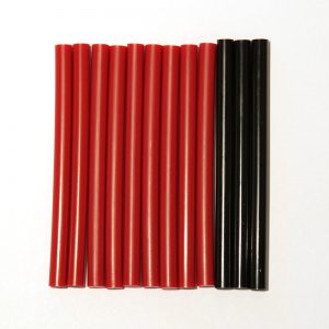 A group of MultiSim® Red and Black Glue Sticks on a white surface.