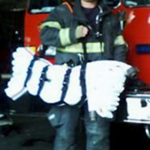 A firefighter standing in front of an EP044 SCBA PAK.