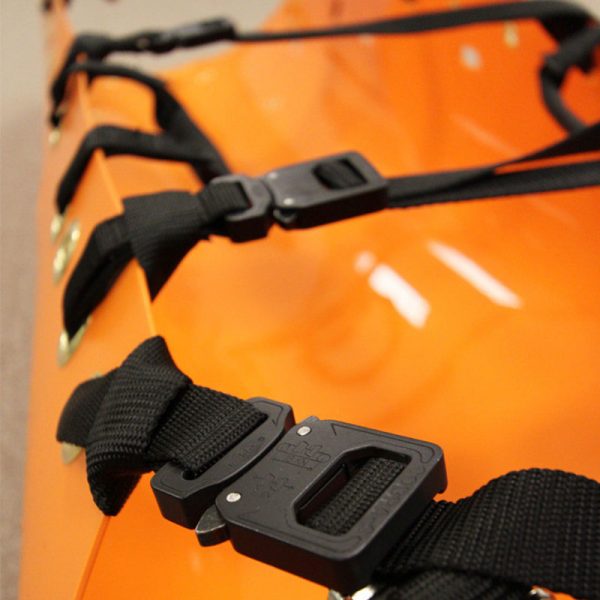 A close up of an SKED-EVAC® Aluminum Side Release Buckle Conversion Kit with black straps.