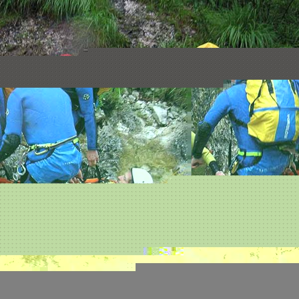 A group of people are rescuing a person in a river using the Sked® Stretcher – International Orange – Stretcher Body Only.