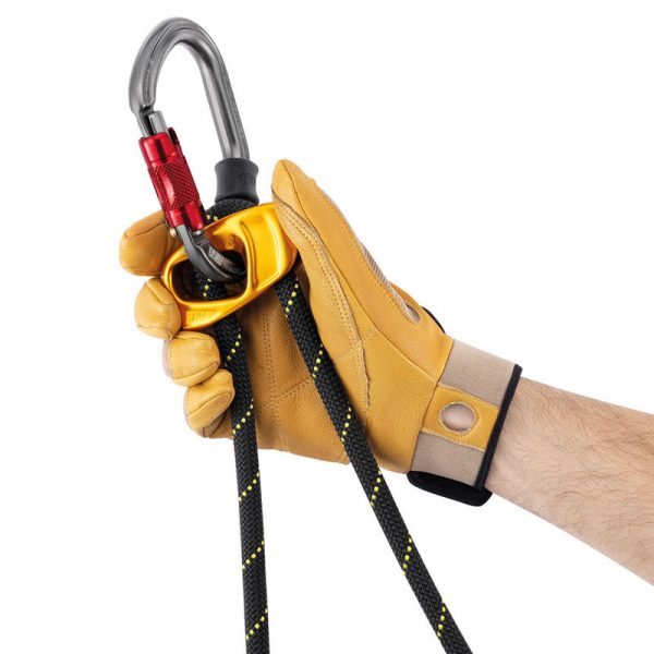 A hand holding a carabiner with a rope attached to it.