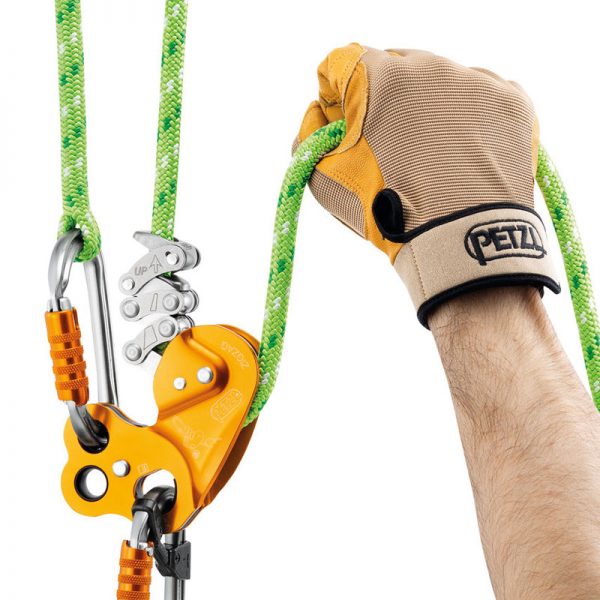 A hand holding a ZIGZAG® and a climbing harness.