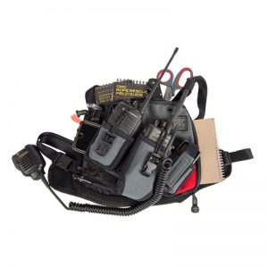 A HARNESS, UTILITY, CMC with a radio and other items.