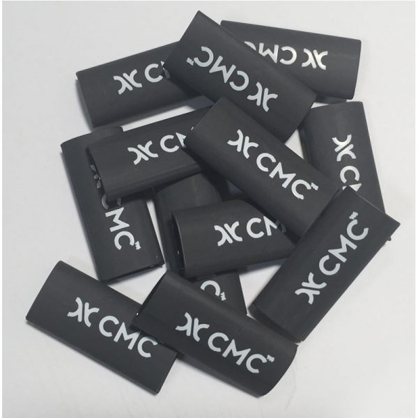 A pile of LADDERLINE, 3/8, CMC black plastic pieces with the word dcc on them.