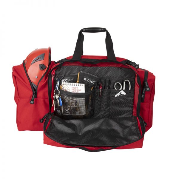 A red duffel bag with several items inside.