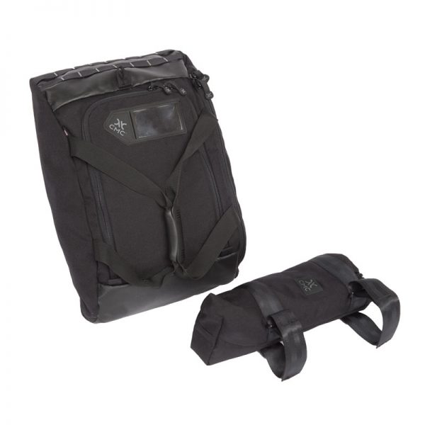 A black SYSTEM bag with two straps on it.